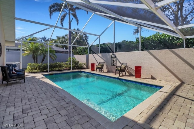 view of pool featuring a patio and glass enclosure