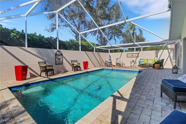 view of pool with a lanai and a patio area