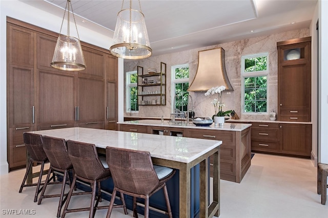 interior space with light stone counters, tasteful backsplash, and pendant lighting