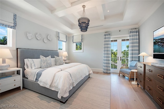 bedroom featuring beamed ceiling, light hardwood / wood-style flooring, coffered ceiling, access to exterior, and french doors