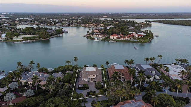 aerial view at dusk with a water view