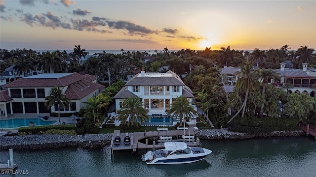 aerial view at dusk with a water view