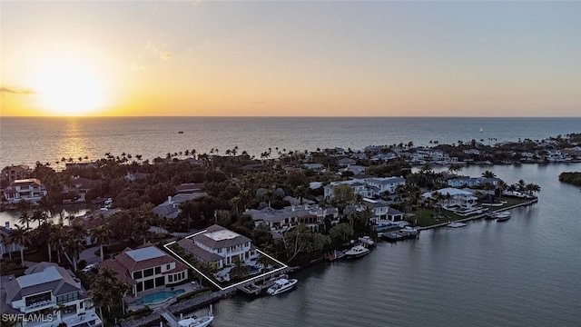 aerial view at dusk with a water view