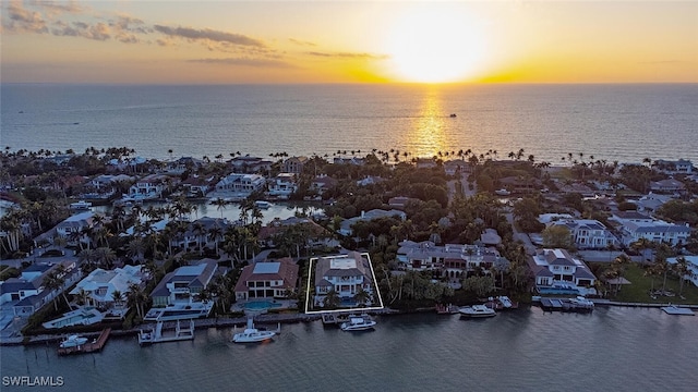 aerial view at dusk with a water view