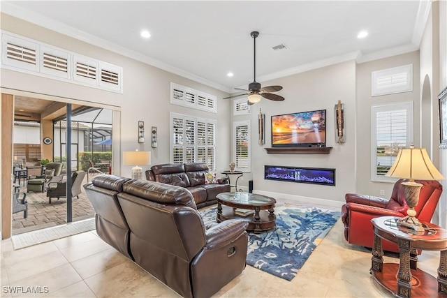 living room featuring crown molding, ceiling fan, and plenty of natural light