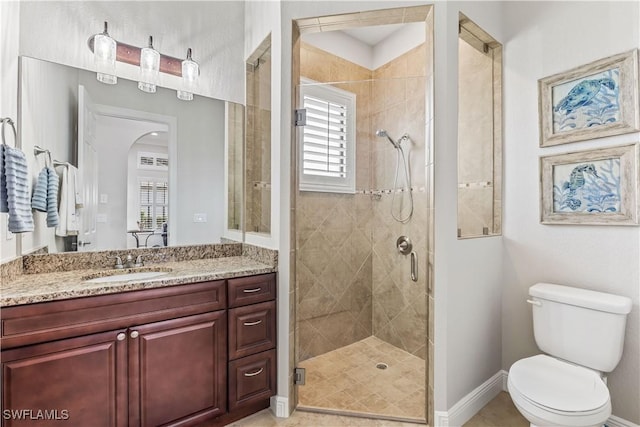 bathroom with walk in shower, vanity, and toilet