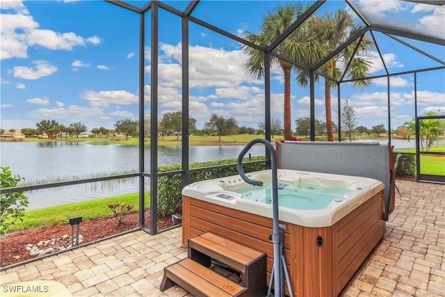 sunroom featuring a jacuzzi and a water view