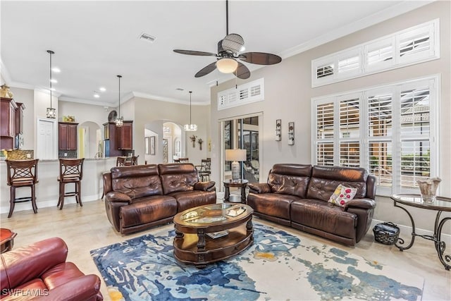 tiled living room with crown molding and ceiling fan