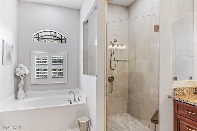 bathroom with vanity and independent shower and bath