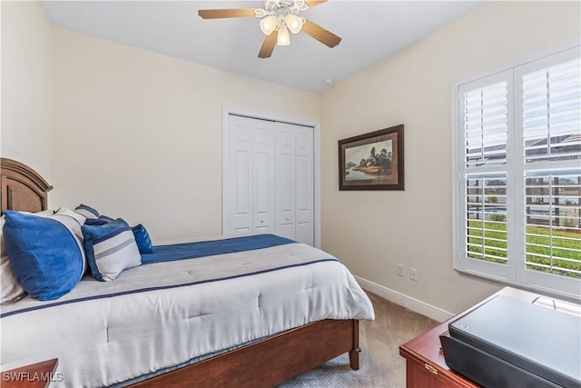 bedroom with light colored carpet, a closet, and ceiling fan