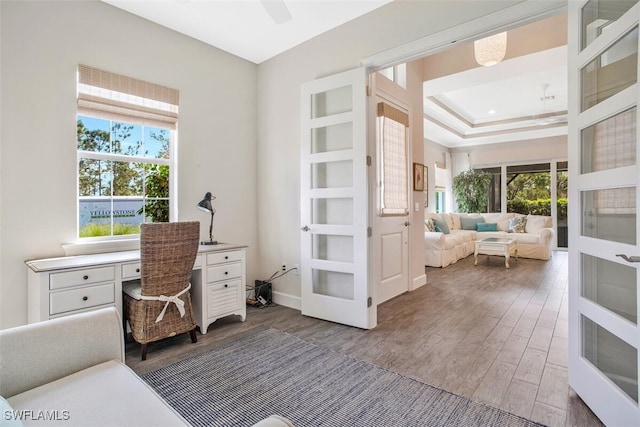 office with ceiling fan, dark wood-type flooring, french doors, and a healthy amount of sunlight