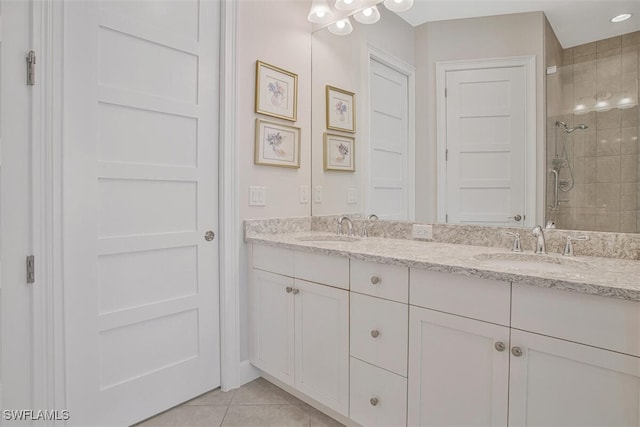 bathroom featuring tile patterned flooring, vanity, and a shower with door