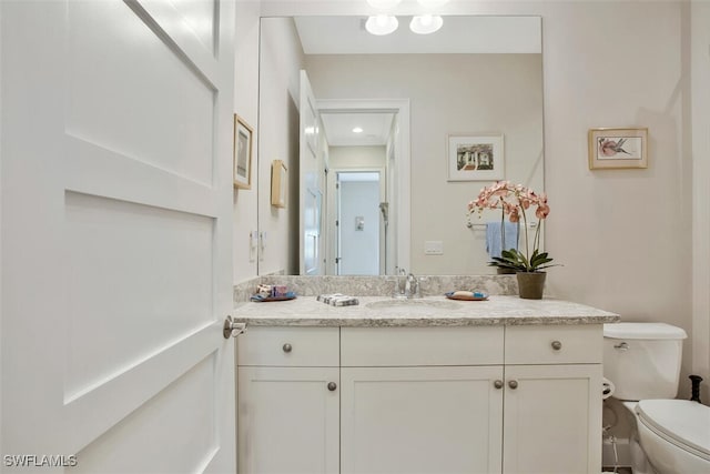 bathroom with vanity and toilet