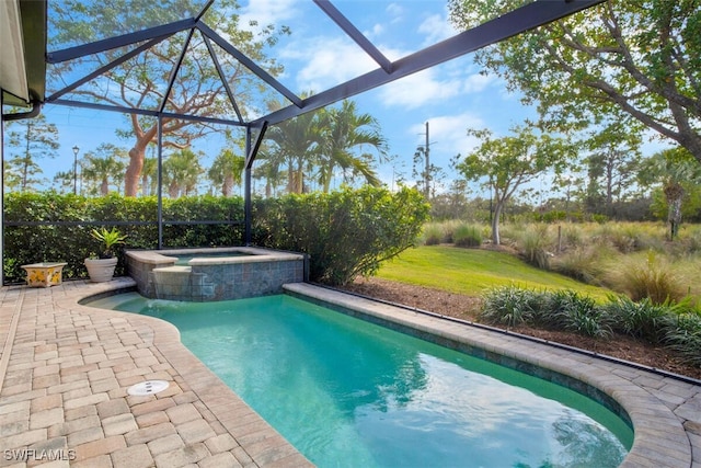 view of swimming pool with an in ground hot tub, glass enclosure, and a patio area