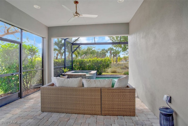 sunroom / solarium featuring ceiling fan and a jacuzzi