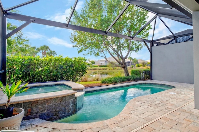 view of pool featuring a patio area, glass enclosure, and an in ground hot tub