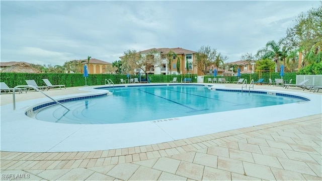 view of swimming pool featuring a patio