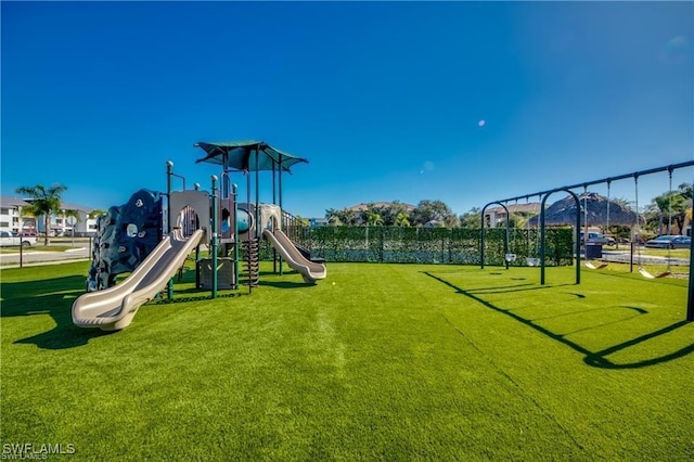 view of jungle gym featuring a lawn