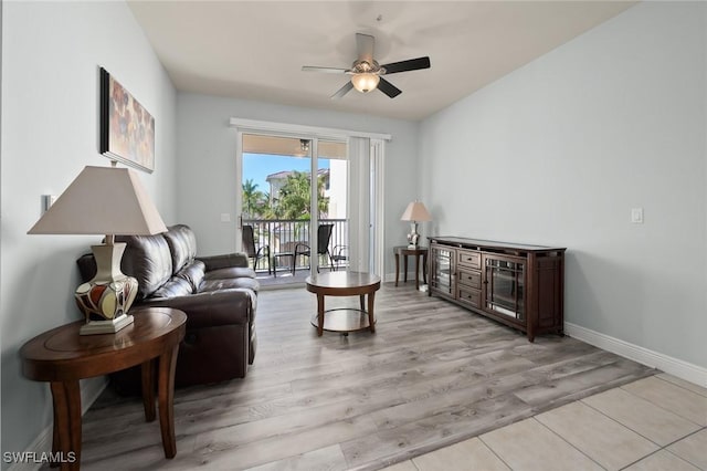 living room featuring light hardwood / wood-style flooring and ceiling fan