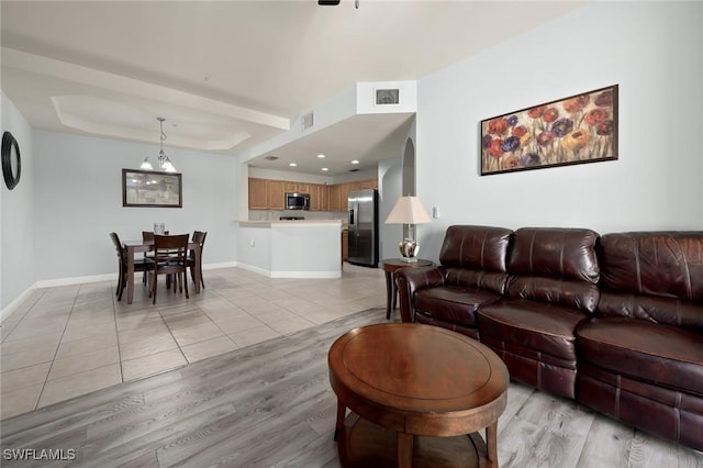 tiled living room with a raised ceiling