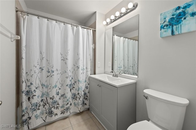 bathroom with vanity, toilet, and tile patterned flooring