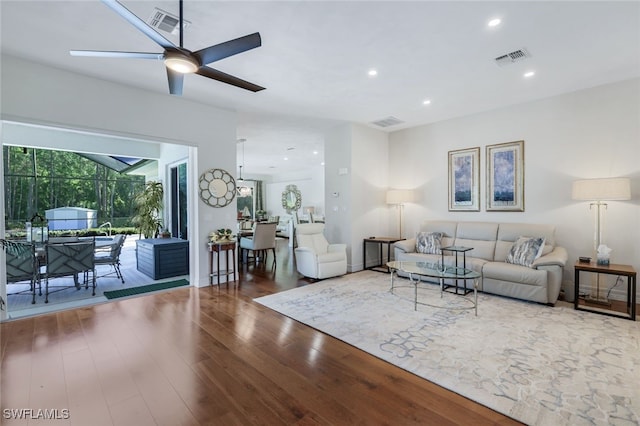 living room featuring hardwood / wood-style flooring and ceiling fan