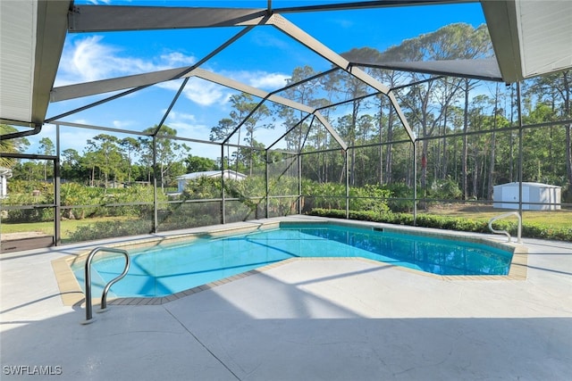 view of swimming pool with a lanai, a shed, and a patio area