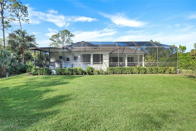 back of house with a lanai and a lawn