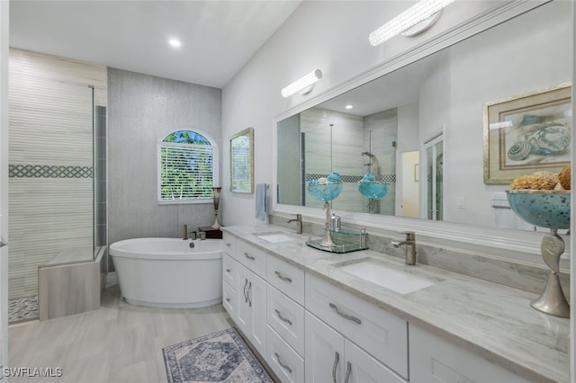 bathroom with vanity and independent shower and bath