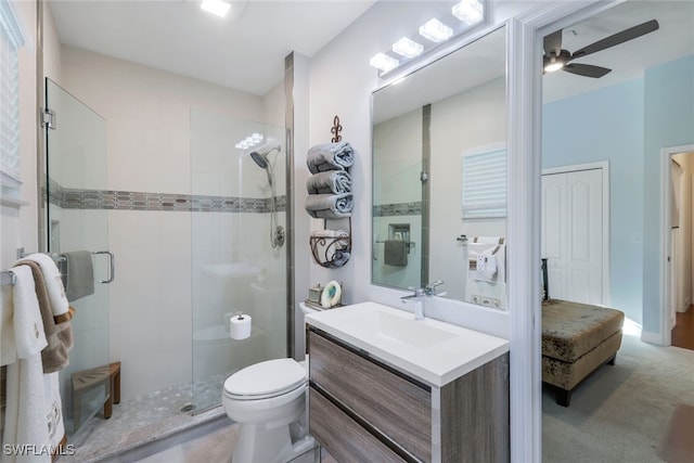 bathroom with vanity, an enclosed shower, ceiling fan, and toilet