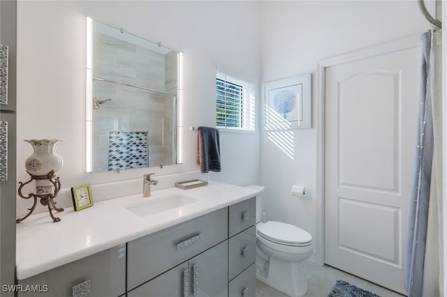 bathroom with vanity, toilet, and walk in shower