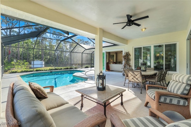 view of swimming pool featuring ceiling fan, an outdoor living space, glass enclosure, and a patio