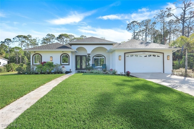 view of front facade with a garage, a front yard, and french doors