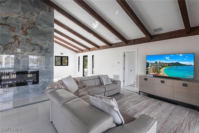 living room featuring a premium fireplace and vaulted ceiling with beams