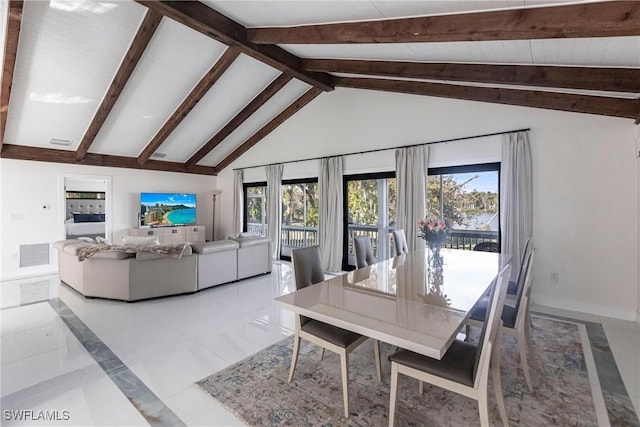 dining area featuring beamed ceiling, a healthy amount of sunlight, and high vaulted ceiling