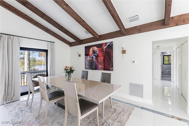 tiled dining space with lofted ceiling with beams