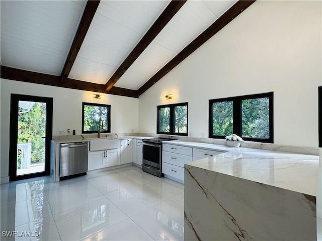 kitchen featuring sink, white cabinetry, stainless steel appliances, light stone countertops, and kitchen peninsula