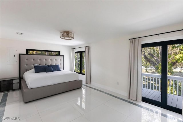 bedroom featuring access to exterior, electric panel, and light tile patterned floors