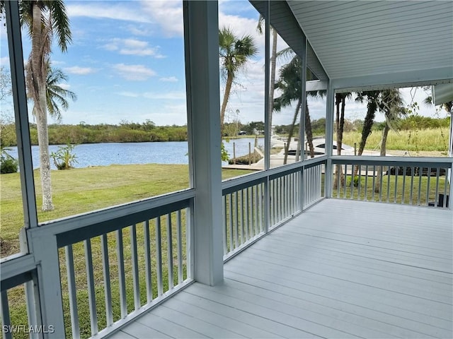 deck featuring a water view and a lawn