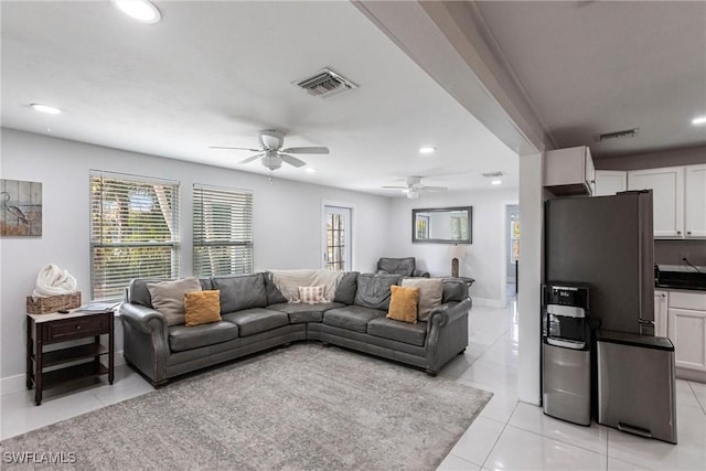 living room featuring ceiling fan, plenty of natural light, and light tile patterned floors