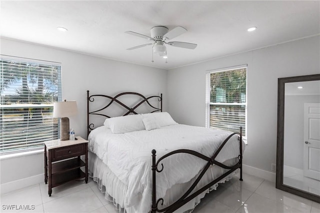 tiled bedroom featuring ceiling fan