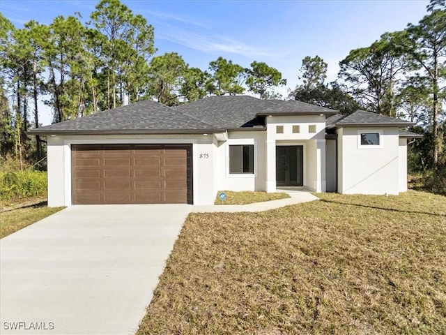 prairie-style house with a garage and a front lawn