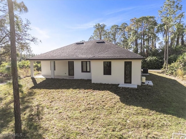 rear view of house featuring a yard and a patio area