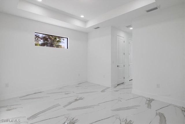 empty room featuring a tray ceiling