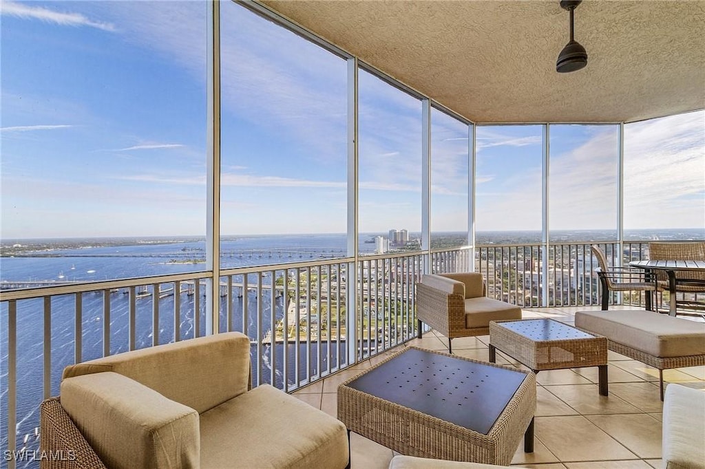 sunroom / solarium with a water view