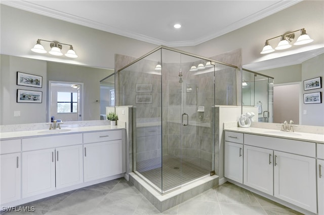 bathroom featuring vanity, crown molding, a shower with shower door, and tile patterned floors