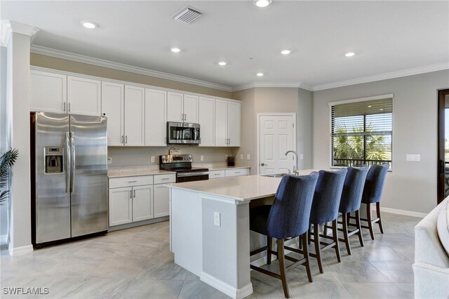 kitchen featuring white cabinetry, an island with sink, and appliances with stainless steel finishes