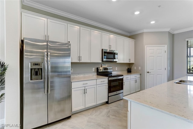 kitchen featuring sink, white cabinetry, light stone counters, ornamental molding, and stainless steel appliances