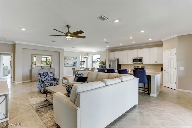 living room featuring sink, crown molding, and ceiling fan