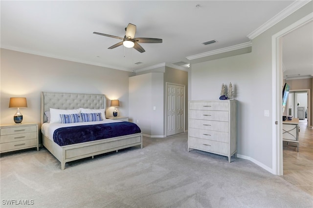 bedroom with ornamental molding, light colored carpet, and ceiling fan